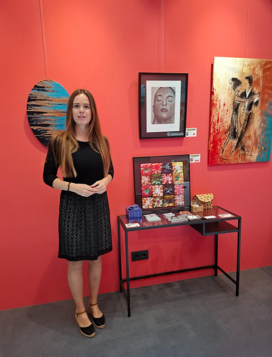 Janis Baer at charity art event "Art for a good reason" at Hotel Artmadams in Mallorca, surrounded by artworks. Charcoal and graphite art exhibitions.