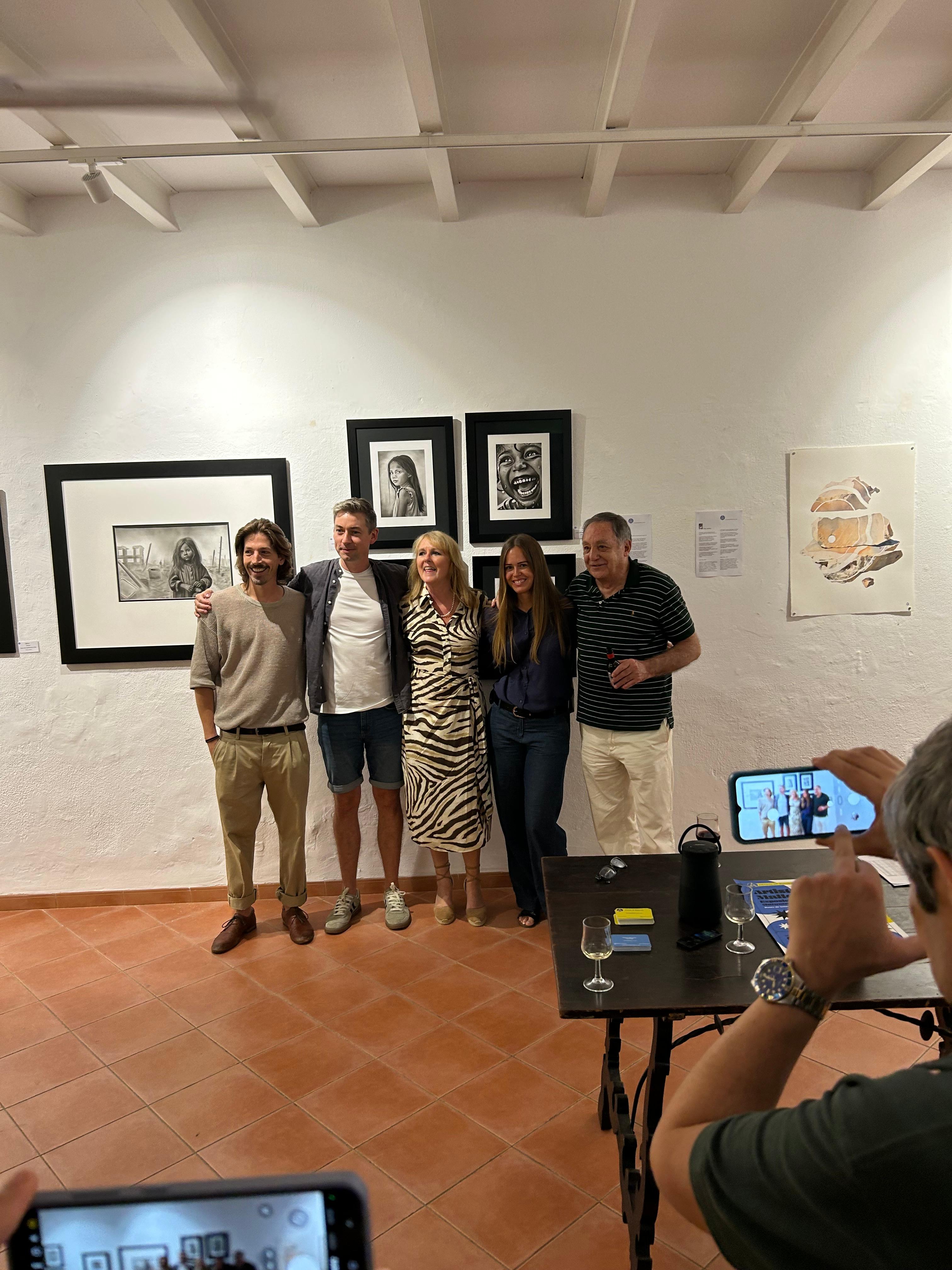 Group exhibition at Museu de Sóller in Mallorca with charcoal and graphite portraits by Janis Baer on the wall