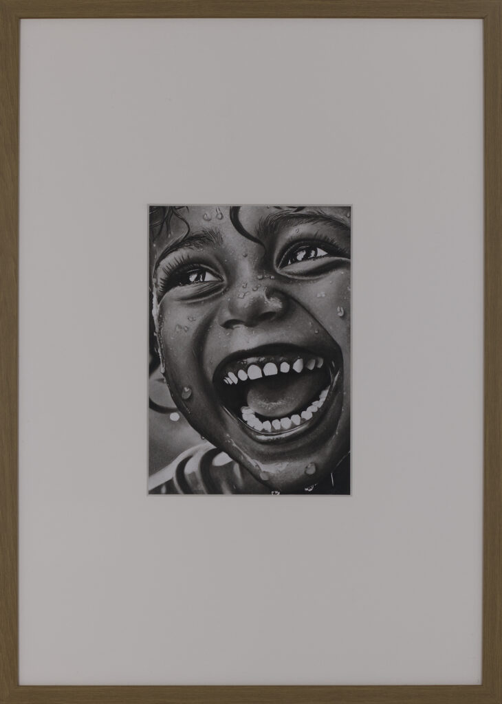 Framed presentation of Before Fear (2025), a contemporary charcoal portrait by Janis Bär with passepartout and oak frame.