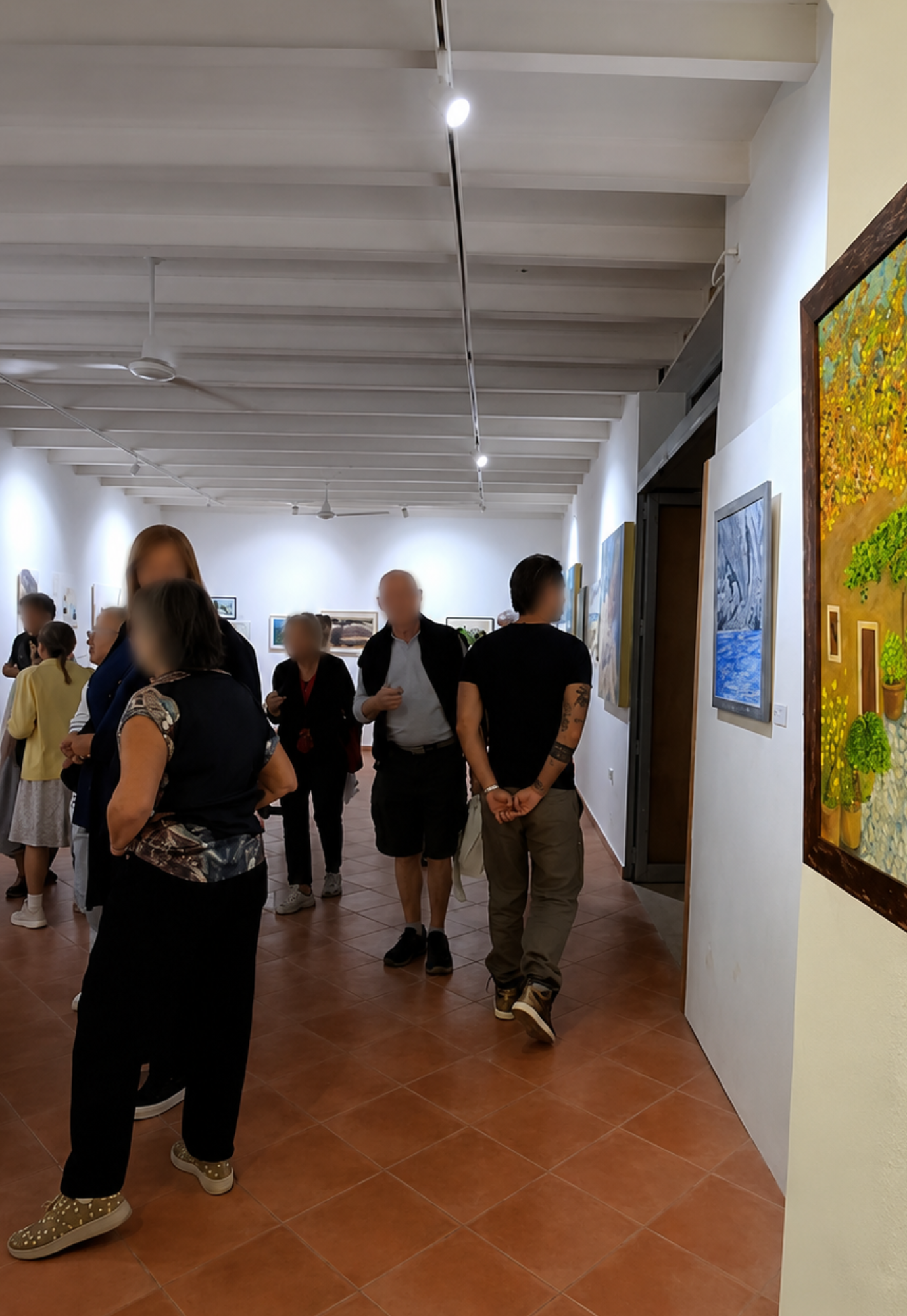Visitors walking through the exhibition galleries during the Artists of Mallorca Autumn Exhibition 2025 at Museu de Sóller, Mallorca.
