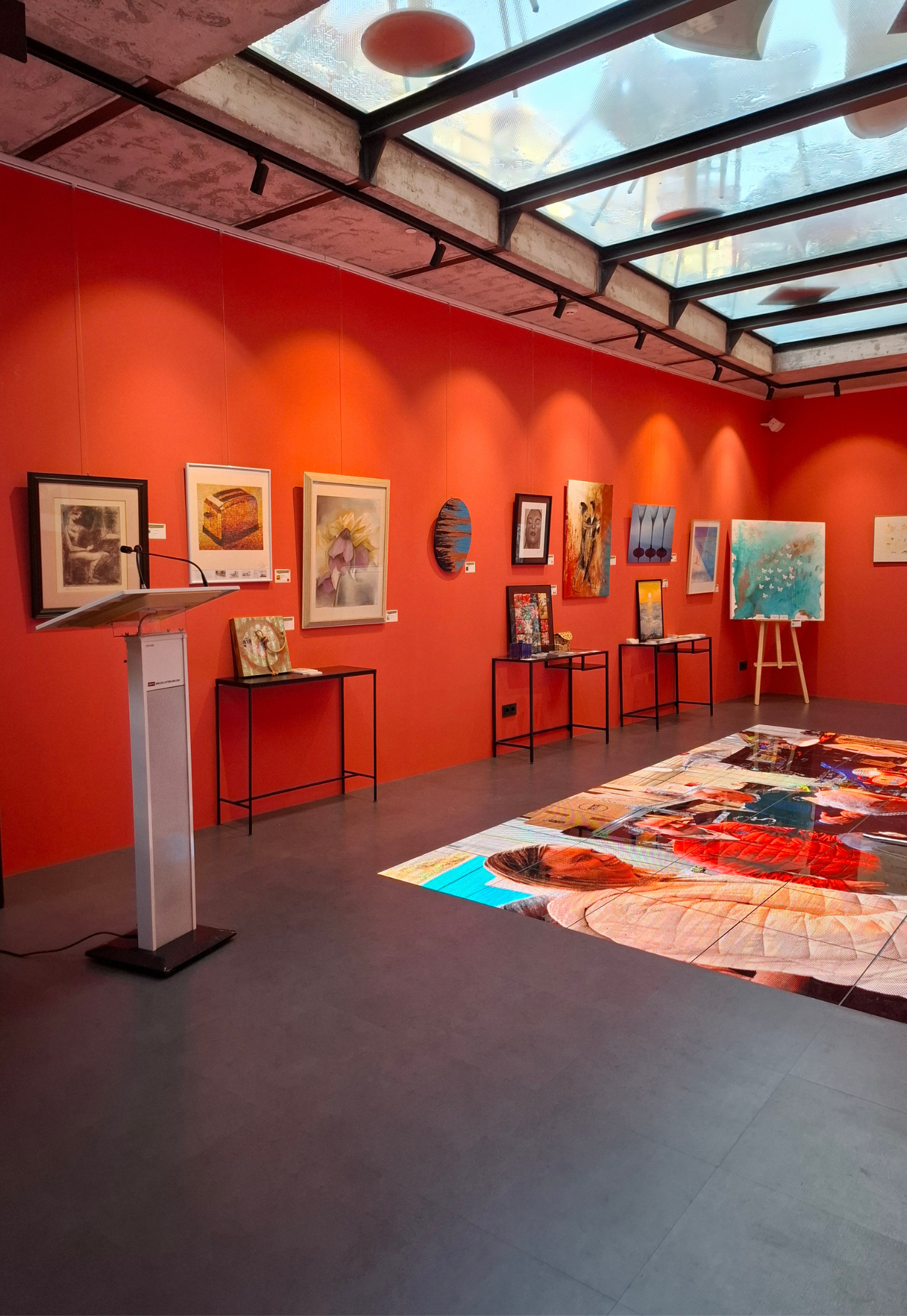 Interior view of the ART for a Good Reason exhibition at Gallery Hotel Artmadams in Palma, featuring displayed artworks and the charity auction area.