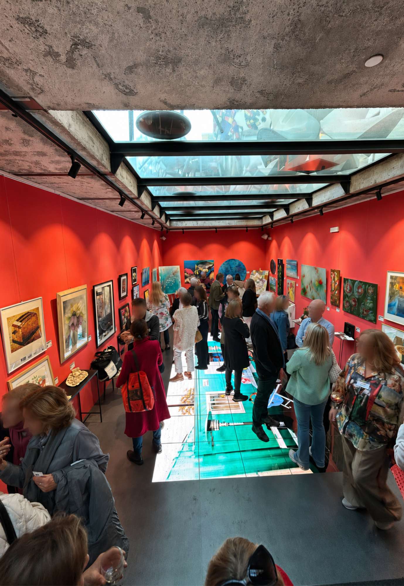Visitors viewing artworks during the ART for a Good Reason charity exhibition at Gallery Hotel Artmadams in Palma, Mallorca.