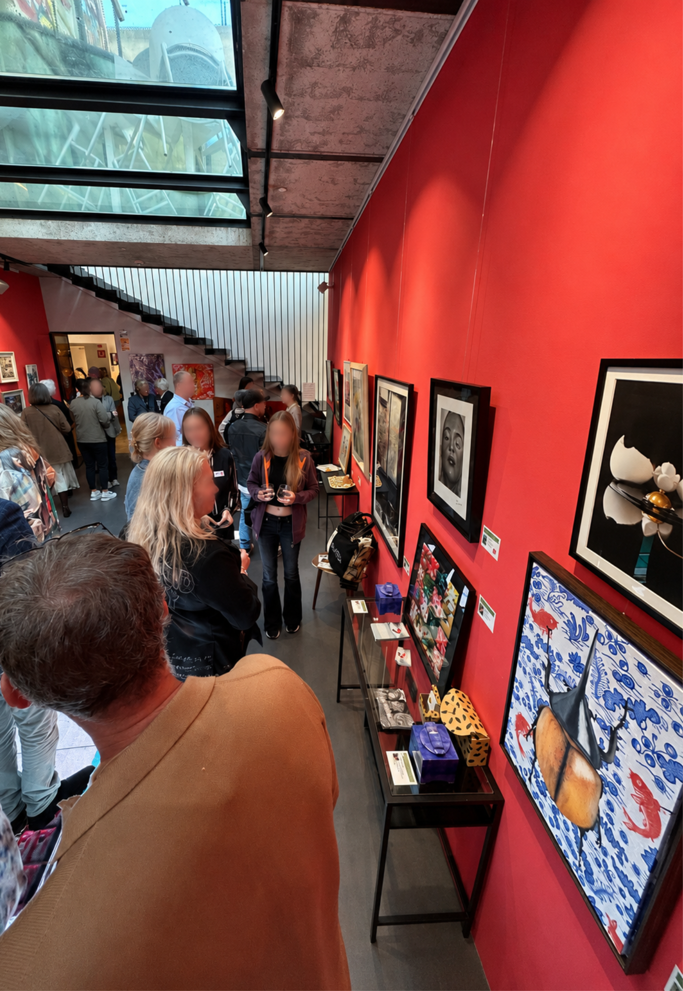 Visitors viewing artworks during the ART for a Good Reason charity exhibition at Gallery Hotel Artmadams in Palma, Mallorca.